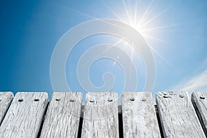 Wooden platform with summer cloudy sky background