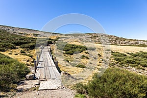 Wooden platforms trail to the Laguna Grande de Gredos in Sierra de Gredos mountains, Spain photo
