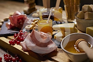 Platter of cold cuts and cheeses with spicy mustard jams and snacks