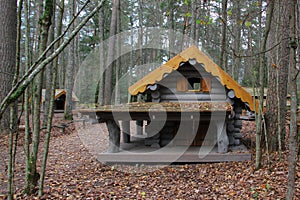 Wooden playhouse for kids. Log house on a playground. Carved wood house for kids` leisure activity