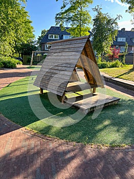 Wooden playhouse for kids on sunny day