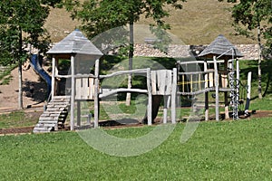 Wooden playset in a public, open playground in Trentino