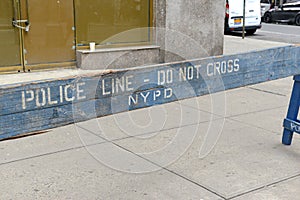 Wooden police barrier with white stenciled lettering