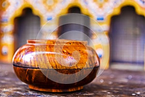Wooden polished monk`s alms bowl in the courryard of a dzong monastery in Bhutan