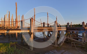 wooden pontoon lighting by sun at sunset in atlantic ocean