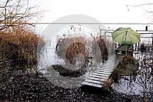 Wooden pontoon pier with fisherman equipment at sunrise lake medoc of Maubuisson Carcans France