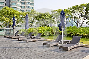 Wooden Pool beds and umbrella with daylight