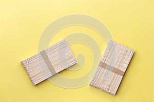 Wooden popsicle sticks on yellow background. Ice cream wooden sticks,Ice lolly sticks.