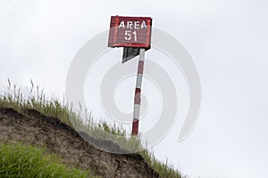 wooden post on a cliff. on it is the inscription Area 51