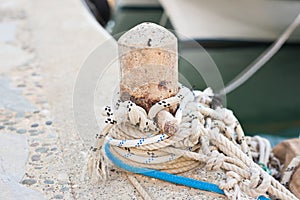Wooden post with mooring ropes for tying boats and ships