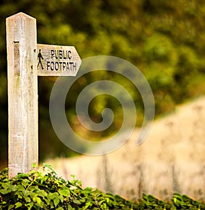 Wooden post saying public footpath