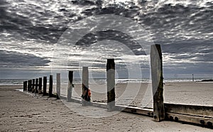 Wooden posts at the seashore in northern Wales photo