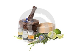 Wooden pounder with bottles of organic oils and photo
