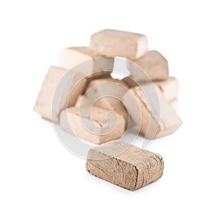 Wooden pressed briquettes from biomass on a white isolated background