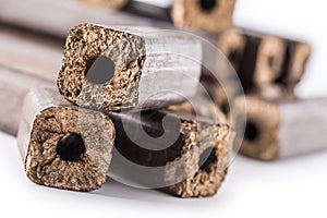 Wooden pressed briquettes Pini Kay from biomass. photo