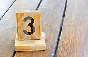 Wooden priority number 3 on a plank tab