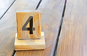 Wooden priority number 4 on a plank tab