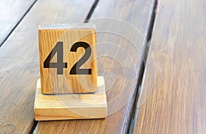 Wooden priority number 42 on a plank tab