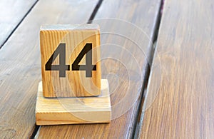 Wooden priority number 44 on a plank tab