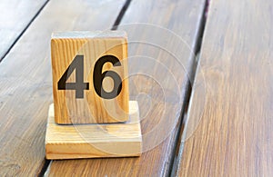 Wooden priority number 46 on a plank tab