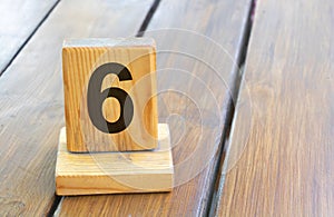 Wooden priority number 6 on a plank tab