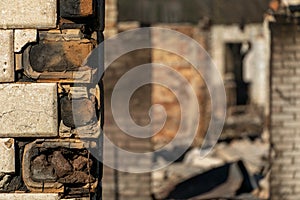 A wooden private house destroyed after a fire. The consequences of a forest fire in the village. Charred walls of a timber house