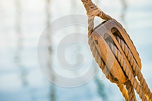 Wooden pulley with nautical ropes of traditional sailboat