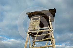 Wooden pulpit for hunters and sky