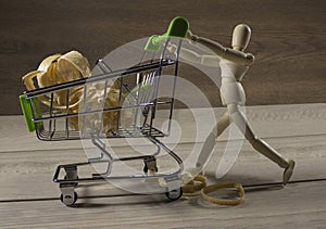 Wooden puppet with shopping cart