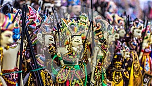 Wooden puppet with traditional batik fabrique called `wayang golek` from Java photo