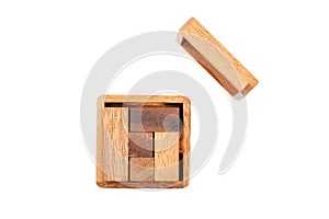 A wooden puzzle is a cube. Isolated on white background. Close-up.