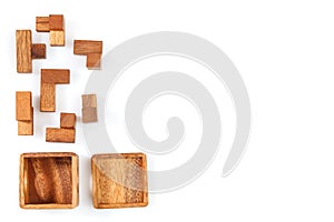 A wooden puzzle is a cube. Isolated on white background. Close-up.