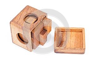 A wooden puzzle is a cube. Isolated on white background. Close-up.