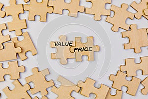 Wooden puzzle pieces with word Value Price Business concept image