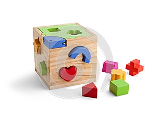 Wooden puzzle toy with colorful blocs isolated over white photo