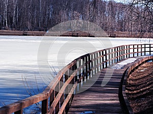 Wooden quay on frozen river landscape background