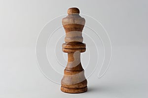 Wooden queen chess figure on grey background