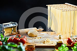 Wooden rack of cooked fettuccine noodles drying
