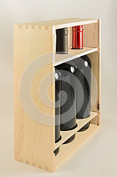 Wooden rack with three wine bottles
