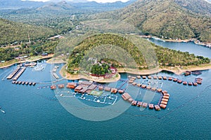 Wooden raft resort floating on dam with mountain at Kanchanaburi
