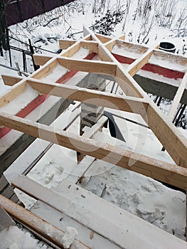 wooden rafters lie on concrete beams, which are based on columns of foam blocks. Preparation of the working space of the house