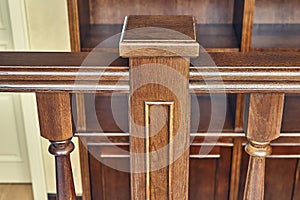 Wooden railing of classic staircase in modern house