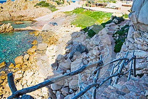 Wooden railing and rocky shore