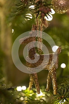 A Wooden Raindeer Suspended from a Christmas Tree