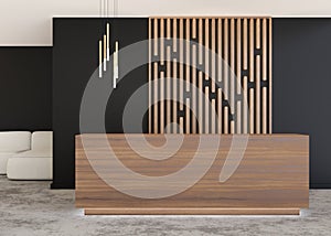 Wooden reception counter in modern room with black walls. Blank registration desk in hotel, spa or office. Reception