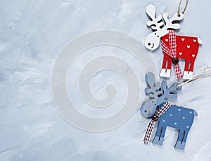Wooden red, blue deer on the grunge gray background. Christmas and New year decoration concept. flat lay