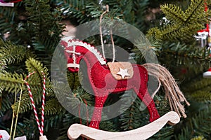 a wooden red horse toy on a Christmas tree, New Year card