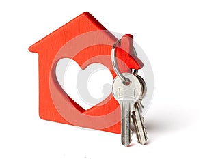 Wooden red house and keys isolated on white background