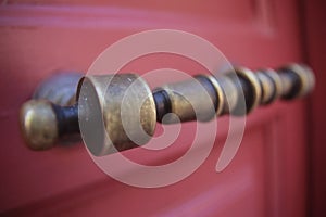 Wooden red old door with vintage brass handle
