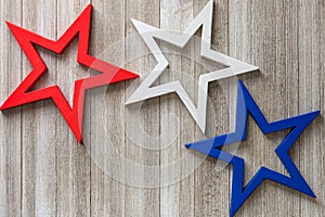 Wooden red, white and blue stars on a rustic background with copy space/4th of July background concept